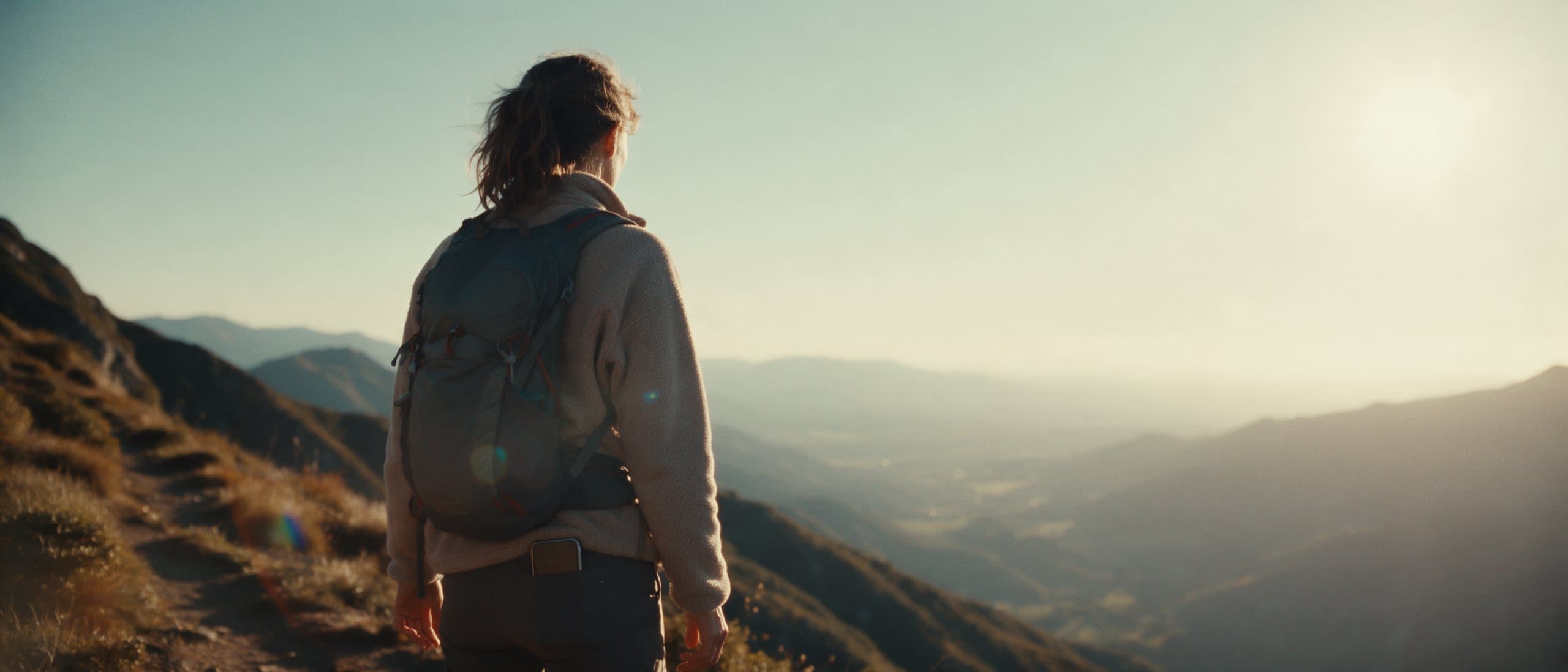 A radiologist on a mountain trail at golden hour